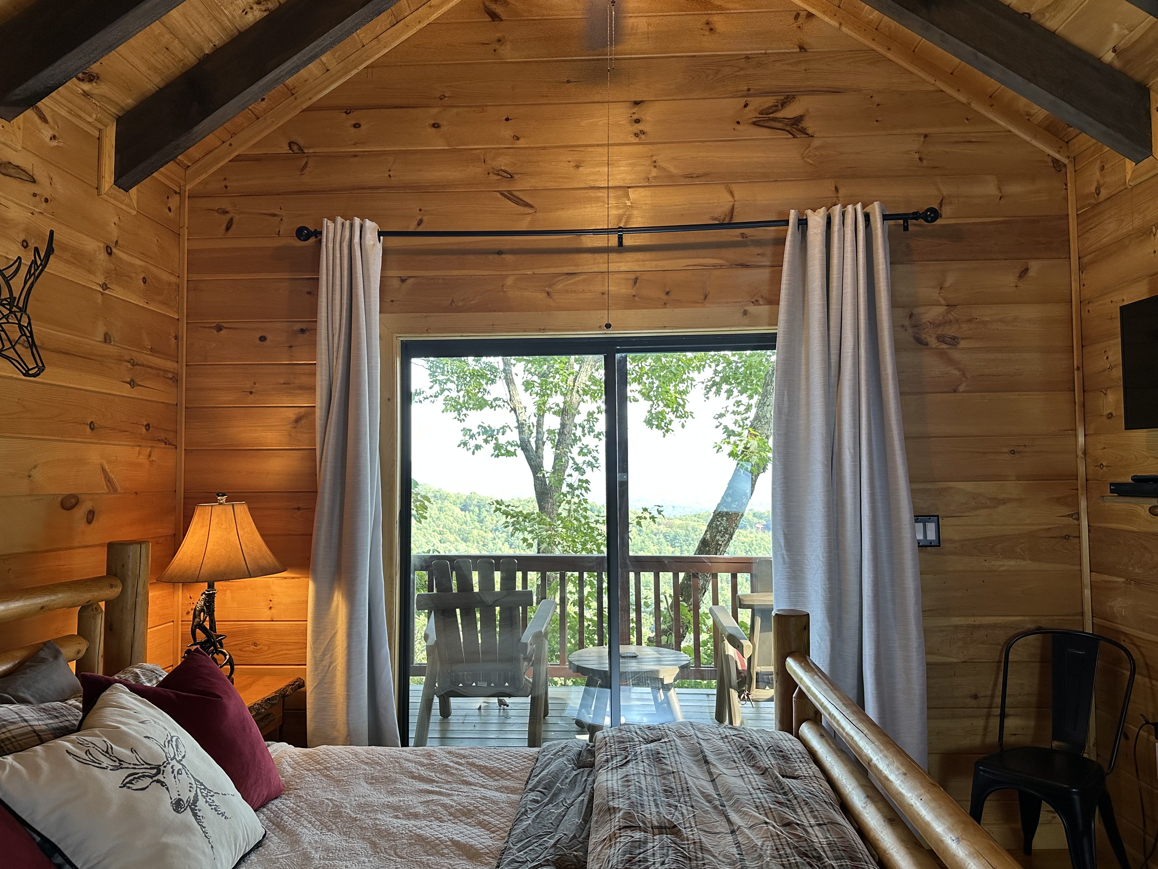 Another view of the upper king suite with cozy mountain-lodge character.